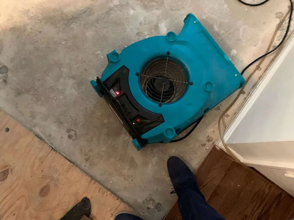 Air mover drying subfloor during Leak Detection & Repair in Dobbs Ferry
